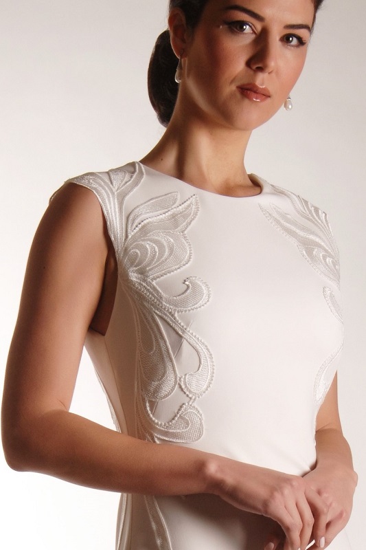 Front detail of this bridal gown shows the beautiful embroidered detail .