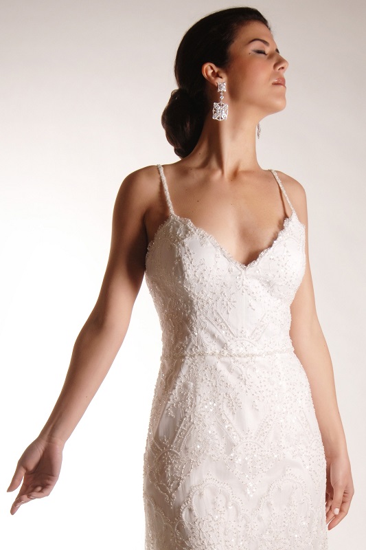A wedding dress with all over lace and french knotted details.